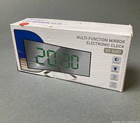 Retail box of DT-6507 mirror electronic clock showing product image and features