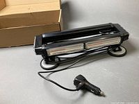 Light bar with power cord and magnetic feet, box in background