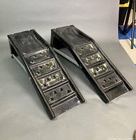 pair of black plastic vehicle ramps side by side