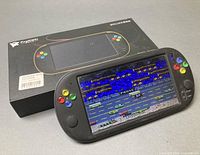 Console powered on in front of box showing gameplay