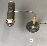 Full view of lamp showing shade, gooseneck, wooden stem, base