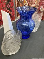 All four vases grouped together showcasing size and designs