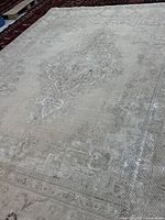 Full view of antique-washed Tabriz rug showing overall design and muted colours