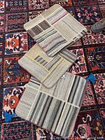 Three square patchwork cushion covers on patterned rug