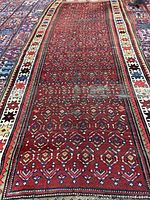 Full view of the Kazak runner showing red field and borders