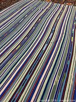 Full view of striped wool kilim rug with blue-green palette