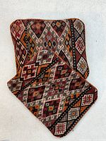 Front view showing geometric kilim pattern on both cushions