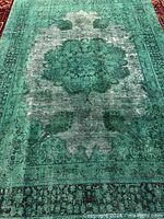 Full view of green overdyed Mashad rug