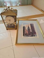 Clock and framed print side by side