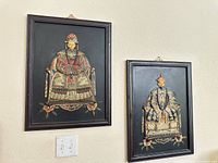 Both framed plaques hanging on wall