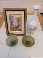 Lot overview showing framed print, porcelain vase and two stone bowls