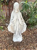 Full view of the Virgin Mary statue standing in garden setting