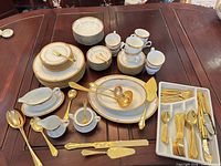 Overview of dinnerware, flatware and serveware spread on table