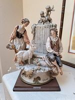 Full view of Armani porcelain figural sculpture on wooden base