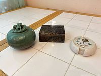 Overall view of green stone lidded jar with lid on