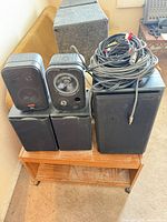 Group shot of all speakers and cable bundle on wooden stand