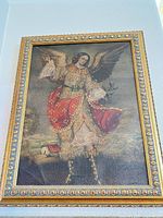 Front view of framed angel canvas print showing artwork and ornate gold frame