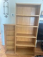 Bookcase beside media rack showing overall design and color