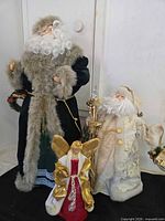 Group shot of both Santas and angel tree topper showing relative sizes and colours