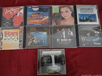 Group shot of all eight CD fronts on red background