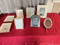 Group shot of eight assorted metal and wood picture frames