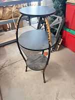 Full view of metal 3-tier plant stand showing overall structure and all shelves