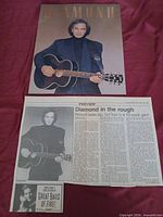 Poster, newspaper clipping, small promo insert visible