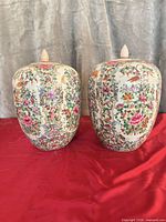 Front view of both ginger jars showing floral decoration and lids