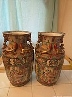 Both vases front view showing overall decoration and form