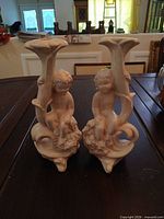 Front view of both porcelain cherub candle holders