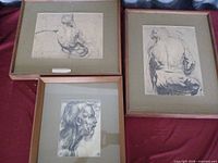 All three framed charcoal/pencil study reproductions on display