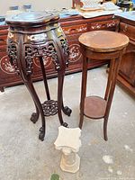 All three stands together showing relative sizes and materials