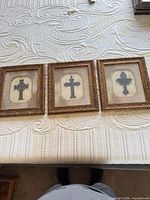 All three framed crosses side by side on surface