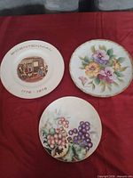 Front view of three M & Z decorative plates