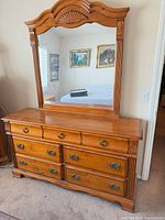 front view of dresser with attached mirror, full shape and drawer layout visible