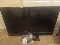 Front view of Sony Bravia LCD TV with accessories bag