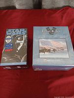 Front view of both sealed VHS boxed sets: Star Wars Trilogy and Victory At Sea