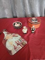 group view of chef-themed plates, shakers, paddle board and tin