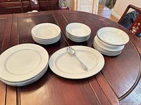 Stacks of bowls, plates and platter on table