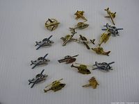 All seventeen airplane and helicopter pins laid out