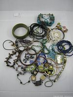 Overview of all 37 bracelets and bangles spread on white background