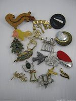 Group shot of all seventeen brooches laid out on white background