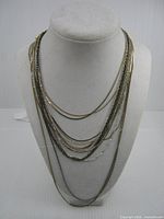 All fifteen necklaces draped on bust form