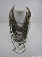 Front view of all seventeen necklaces draped on bust