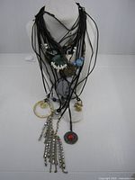 All 17 necklaces displayed on bust showing variety of pendants and cords