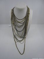 All necklaces layered on bust form showing variety of lengths and finishes