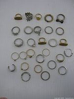 Overview of 29 costume rings arranged on flat surface