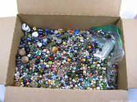 Box filled with assorted loose beads of many colours and shapes