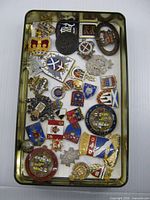 Top view of Rogers tin filled with assorted badges