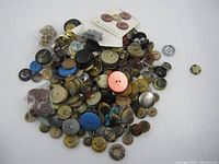 pile of mixed buttons spread on tabletop